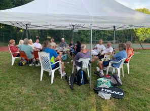 Gathering under large gazebo.