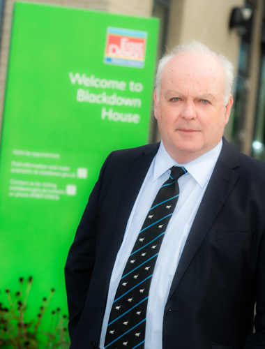 Photo of Cllr Paul Arnott, EDDC's Leader, in front of Blackdown House, Honiton