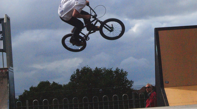 Cyclist riding mid-air on a skate park