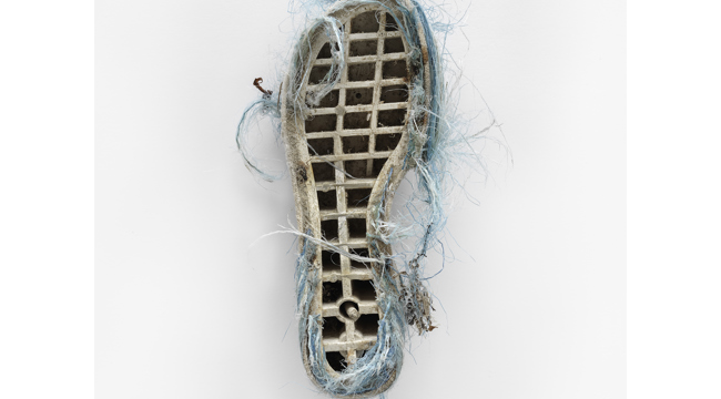 Sole of old shoe with turquoise webbing