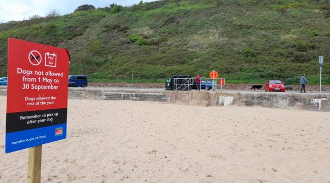 Exmouth beach with public spaces protection order sign 