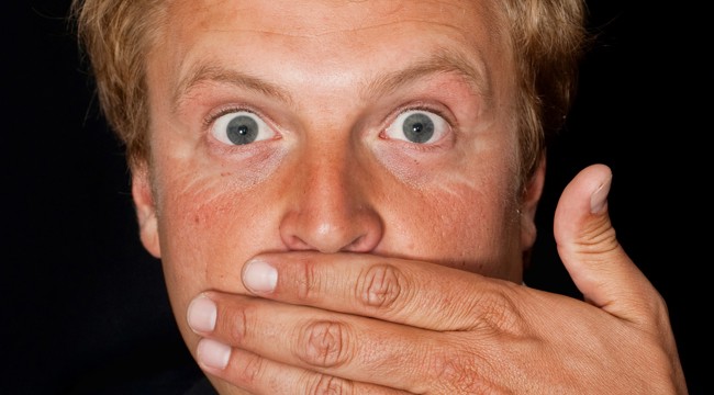 Goronwy Thom, a blonde man with blue eyes poses with his hand over his mouth