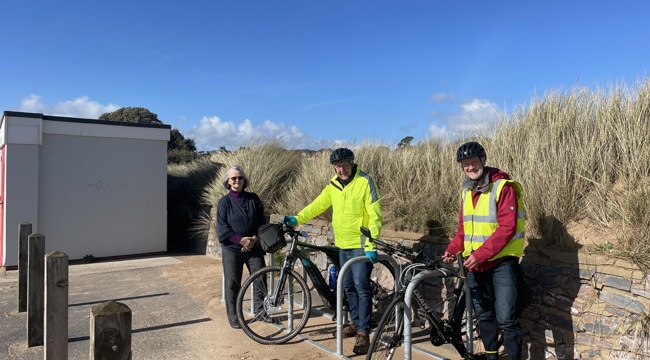 Councillors Marianne Rixson, Olly Davey and Geoff Jung next to the new bike parking spaces on Exmouth seafront