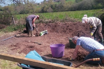 The Eager Beavers digging up soil for the community garden.