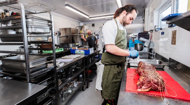 Chef preparing food in a new kitchen funded by Innovation and Resilience Fund