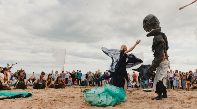 crowd on beach watch a performance 