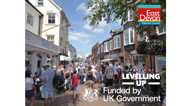 Photo of Sidmouth town centre with East Devon District Council, Levelling Up, and Funded by UK Government logos