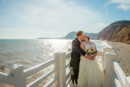 A bride and groom on the beach on their wedding day