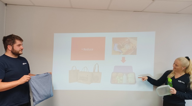Image of recycling officer and contract supervisor in front of white board presentation 