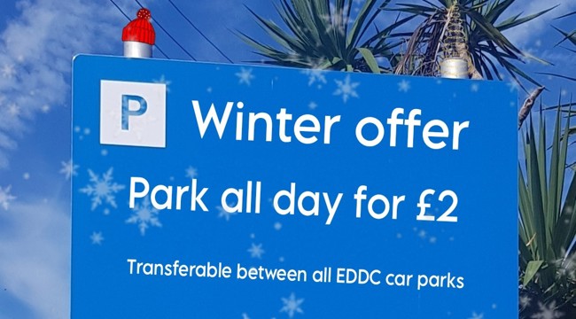 Signpost with text: winter offer, park all day for £2, transferable between all EDDC car parks
