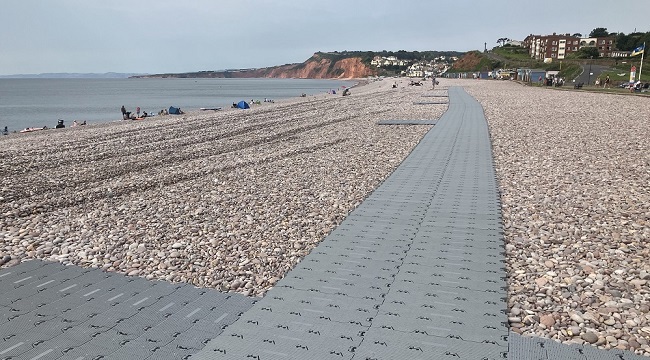 Budleigh Salterton beach with track matting laid out across the pebbles