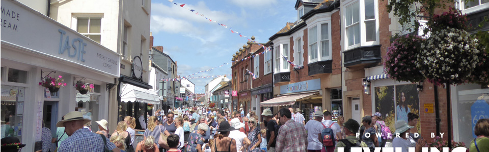 Busy street full of pedestrians in Sidmouth on a sunny summers day