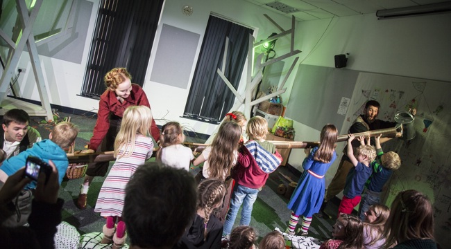 Group of children and adults enjoying a theatre workshop