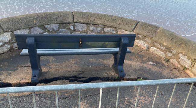 Photo of a crack through the Exmouth seawall below a bench