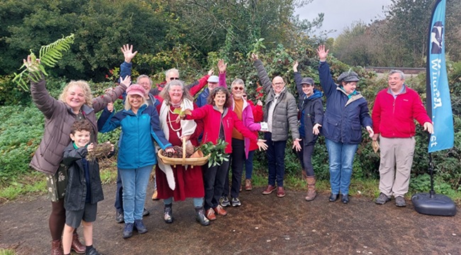 Group of volunteers with their arms raised in celebration
